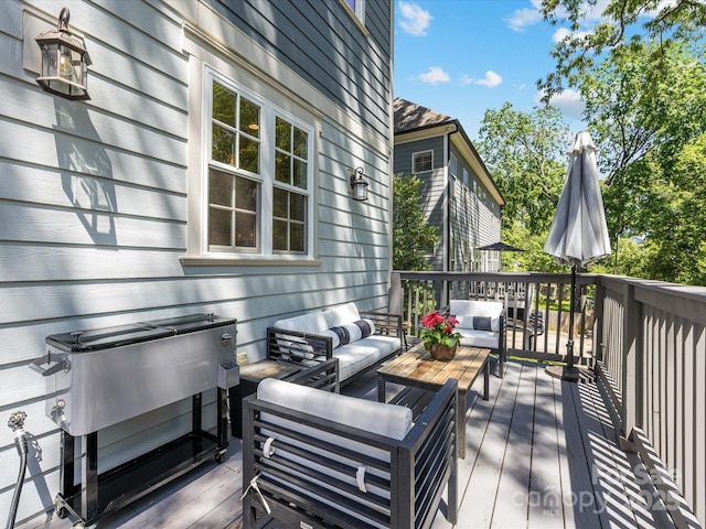 wooden terrace with an outdoor hangout area