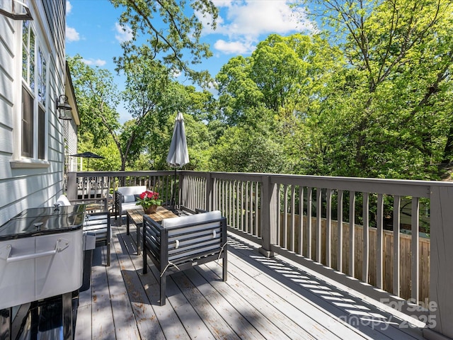 wooden terrace with an outdoor hangout area