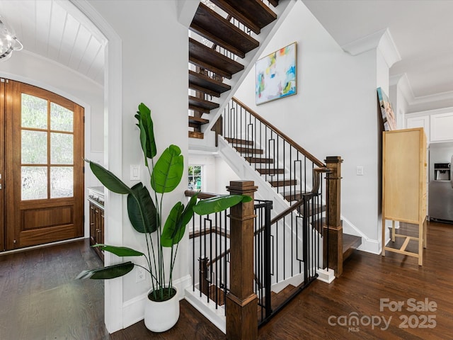 interior space featuring crown molding, stairway, wood finished floors, and a healthy amount of sunlight