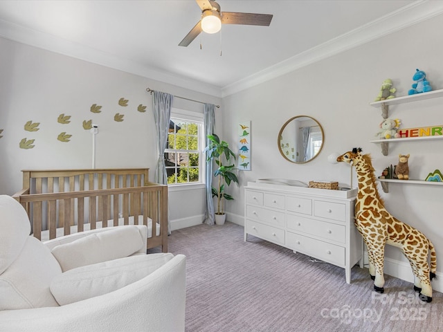 carpeted bedroom with baseboards, ornamental molding, and ceiling fan