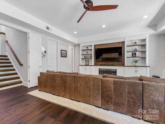 living room featuring visible vents, stairs, ceiling fan, recessed lighting, and dark wood finished floors