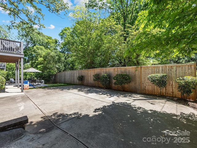 view of patio / terrace featuring a fenced backyard and a balcony