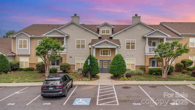 property at dusk featuring uncovered parking