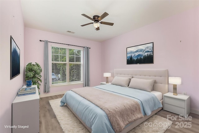 bedroom with light wood-style floors and ceiling fan