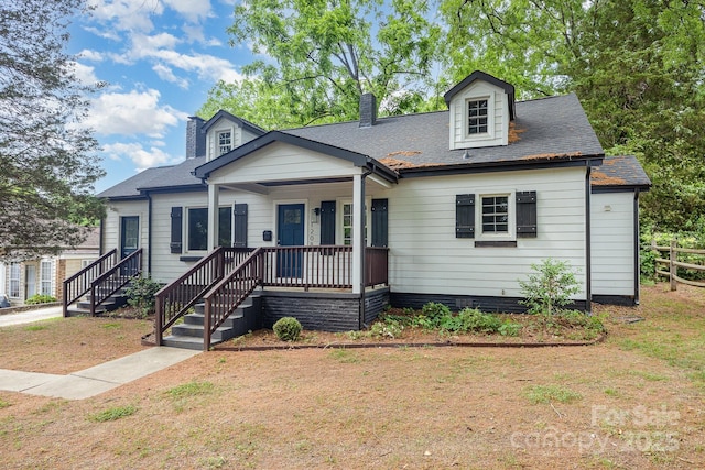 1208 Fordham Rd, Charlotte, NC 28208 - cape cod home featuring a chimney, fence, a porch, and a shingled roof