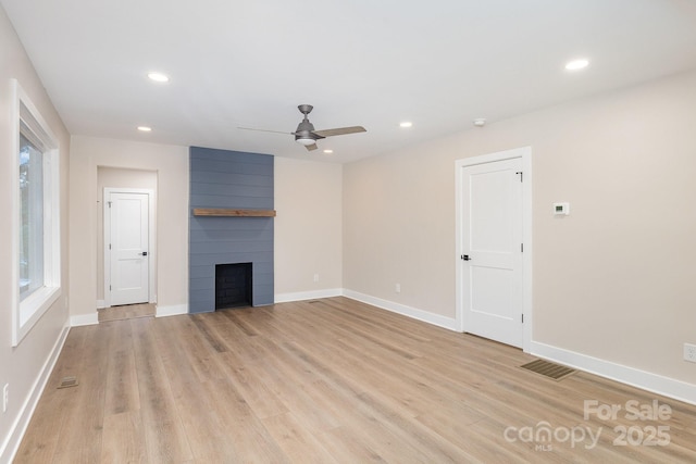 1208 Fordham Rd, Charlotte, NC 28208 - unfurnished living room featuring ceiling fan, a large fireplace, light wood-style flooring, recessed lighting, and baseboards