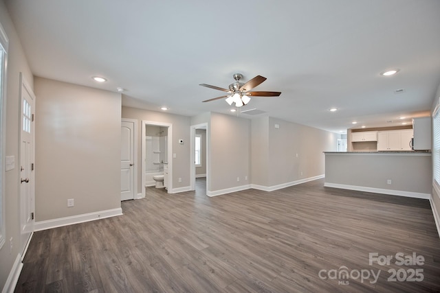 unfurnished living room with recessed lighting, a ceiling fan, and baseboards