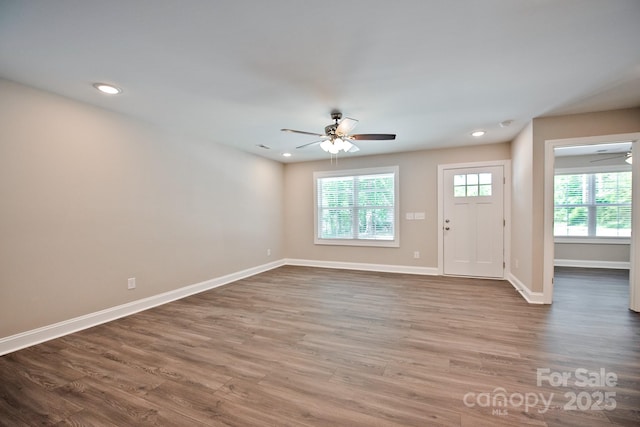 interior space featuring baseboards, a ceiling fan, recessed lighting, and wood finished floors
