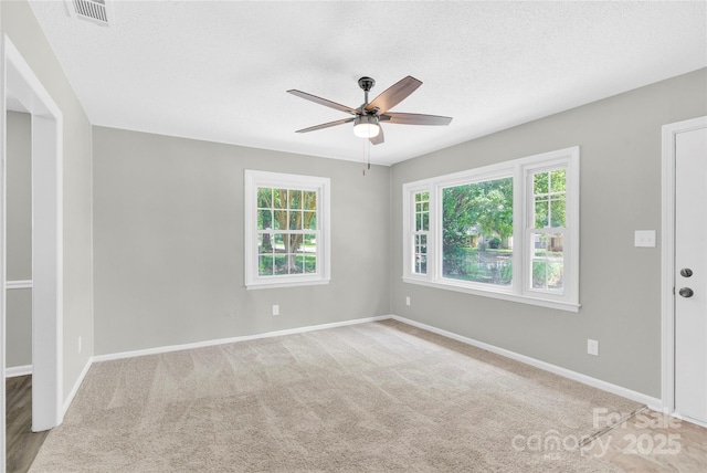 8303 Hemby Wood Dr, Indian Trail, NC 28079 - unfurnished room with healthy amount of natural light, ceiling fan, baseboards, carpet, and a textured ceiling