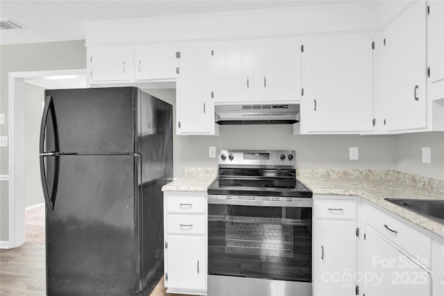 8303 Hemby Wood Dr, Indian Trail, NC 28079 - kitchen featuring freestanding refrigerator, stainless steel electric stove, under cabinet range hood, and white cabinets