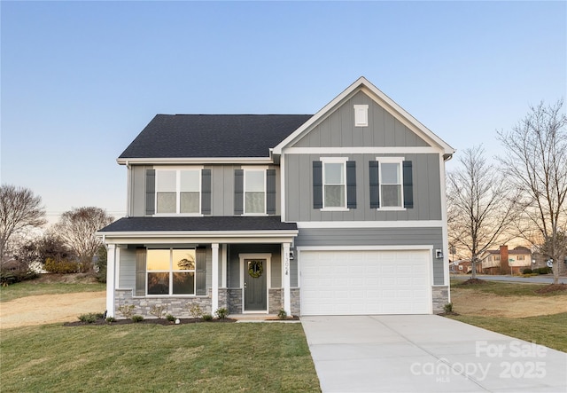 view of front of property with a front lawn, stone siding, a garage, board and batten siding, and concrete driveway