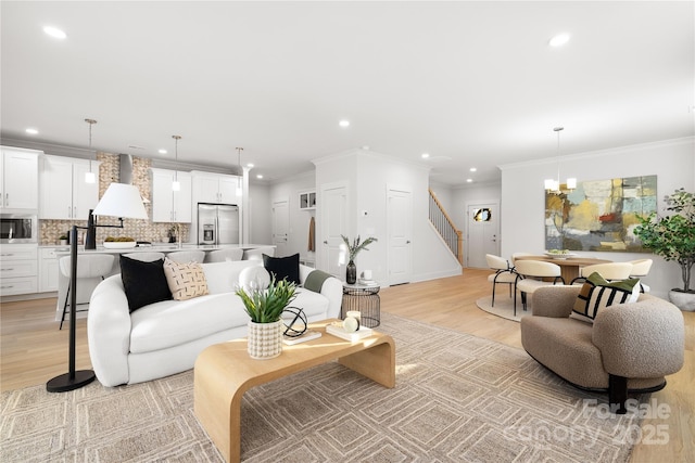 living room with recessed lighting, light wood-style flooring, stairs, and ornamental molding