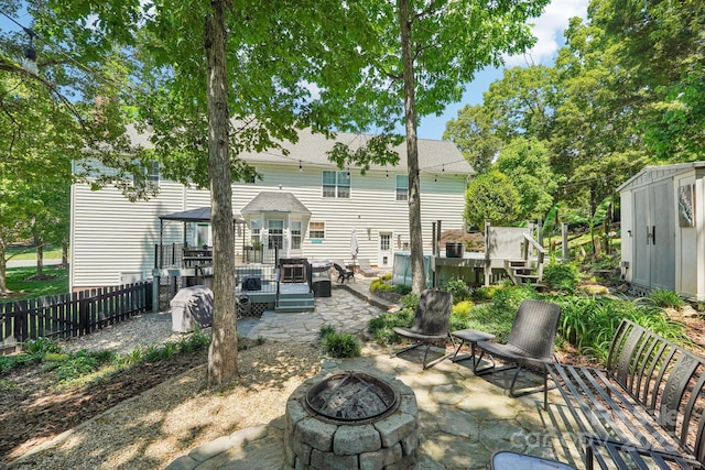 8056 Stevens Mill Rd, Matthews, NC 28104 - back of property with an outdoor fire pit, a patio area, and a deck