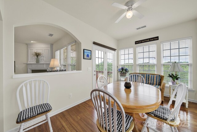 dining area with baseboards, wood finished floors, and visible vents