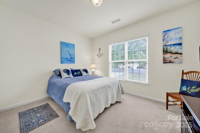 bedroom featuring baseboards, carpet, and visible vents