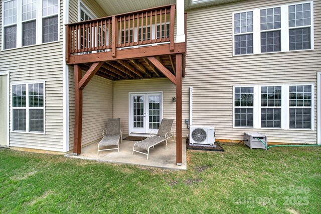 back of house featuring french doors, ac unit, a wooden deck, a yard, and a patio