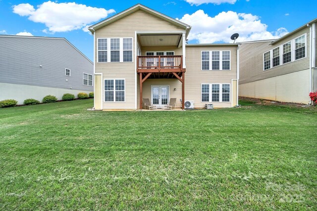 rear view of property with a lawn and french doors