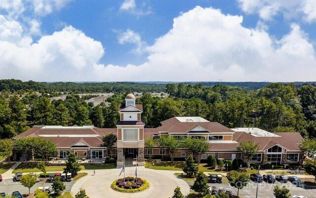 birds eye view of property with a view of trees