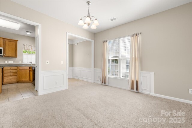16291 Raven Crest Dr, Indian Land, SC 29707 - unfurnished dining area with visible vents, wainscoting, a notable chandelier, and light carpet