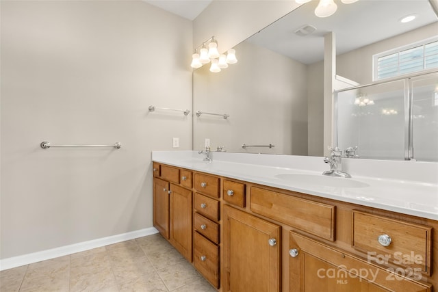 16291 Raven Crest Dr, Indian Land, SC 29707 - bathroom featuring a shower with door, double vanity, baseboards, and a sink