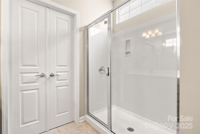 16291 Raven Crest Dr, Indian Land, SC 29707 - full bathroom with tile patterned floors, a chandelier, a shower stall, and baseboards