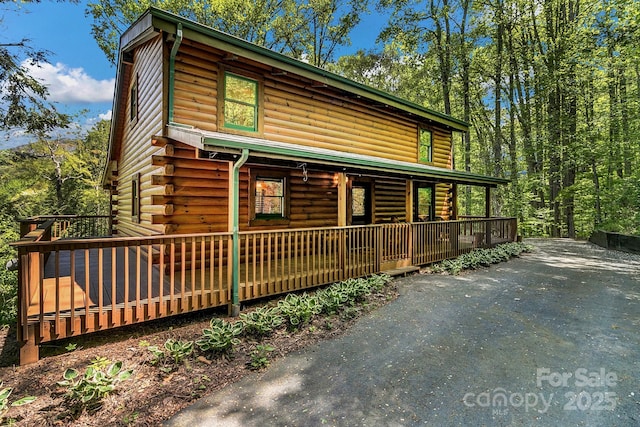 41 Log Cabin Dr, Maggie Valley, NC 28751 - log-style house with covered porch and log siding