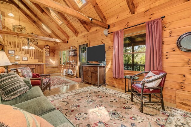 41 Log Cabin Dr, Maggie Valley, NC 28751 - living room with wooden walls, plenty of natural light, beamed ceiling, and wood finished floors