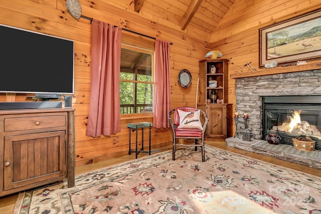 41 Log Cabin Dr, Maggie Valley, NC 28751 - living area with a fireplace, wood walls, wooden ceiling, vaulted ceiling with beams, and wood finished floors