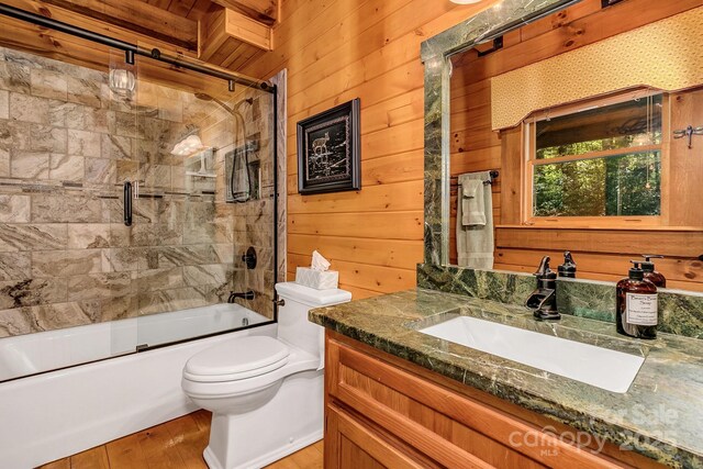 41 Log Cabin Dr, Maggie Valley, NC 28751 - full bath with vanity, toilet, enclosed tub / shower combo, wood walls, and wood finished floors