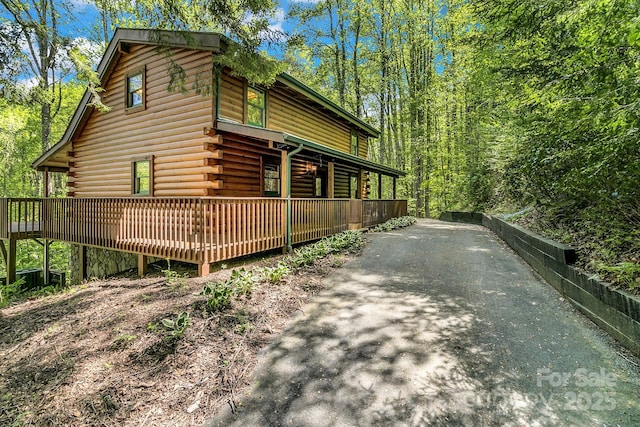 41 Log Cabin Dr, Maggie Valley, NC 28751 - view of side of home featuring driveway, log exterior, and a wooden deck