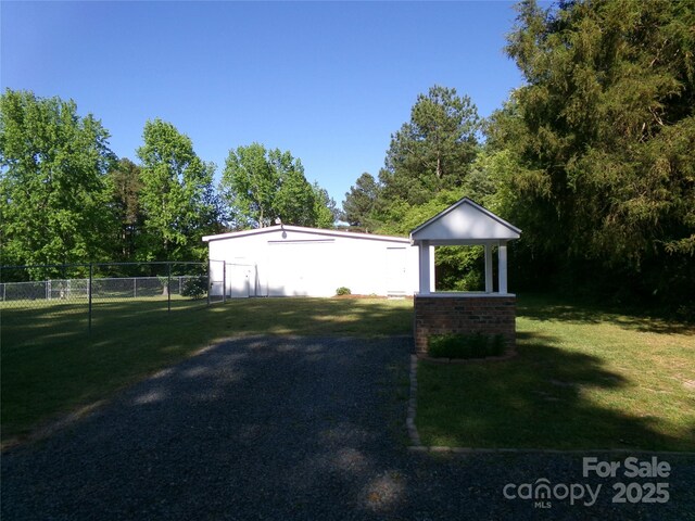 44716 Gold Branch Rd, Richfield, NC 28137 - view of side of property featuring fence, an outdoor structure, a pole building, and a lawn