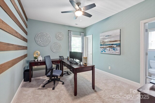 home office with a healthy amount of sunlight, carpet, and a ceiling fan