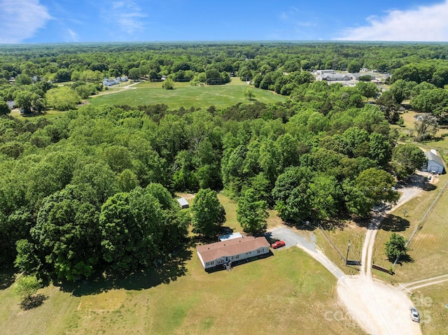 birds eye view of property with a wooded view