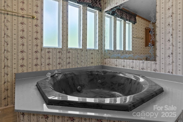 bathroom with plenty of natural light and wallpapered walls