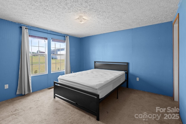 carpeted bedroom with a textured ceiling
