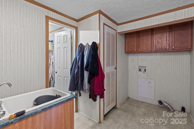 interior space with crown molding, hookup for a washing machine, light floors, wallpapered walls, and cabinet space