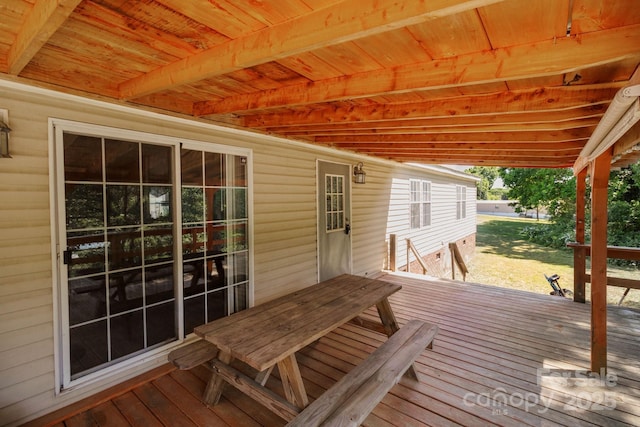 wooden deck featuring a yard