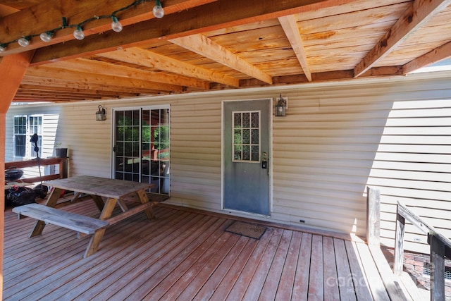 wooden terrace featuring outdoor dining area