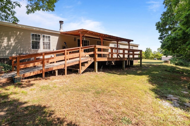 back of property featuring a lawn and a wooden deck