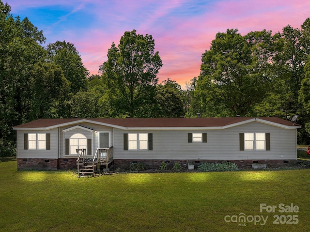 manufactured / mobile home with a front lawn and crawl space