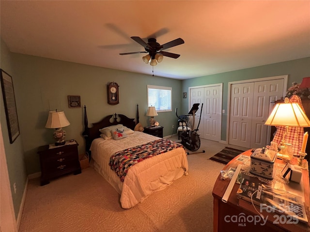 carpeted bedroom featuring multiple closets, baseboards, and a ceiling fan