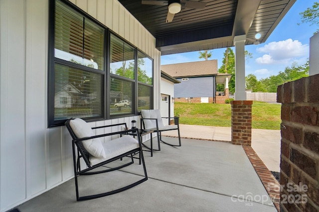 view of patio with fence and a ceiling fan