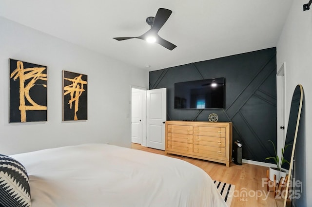bedroom featuring a ceiling fan and light wood finished floors