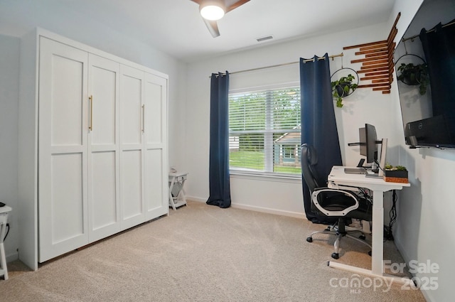 home office with baseboards, light carpet, a ceiling fan, and visible vents