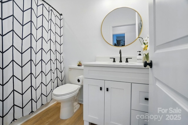 full bathroom with vanity, a shower with shower curtain, wood finished floors, and toilet
