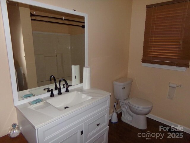 556 Roundtree Cir, Chester, SC 29706 - full bathroom with baseboards, toilet, vanity, a shower, and wood finished floors