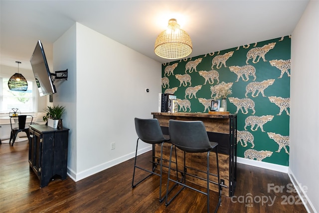 1816 Anderson St, Charlotte, NC 28205 - dining area featuring a bar, baseboards, and wood finished floors