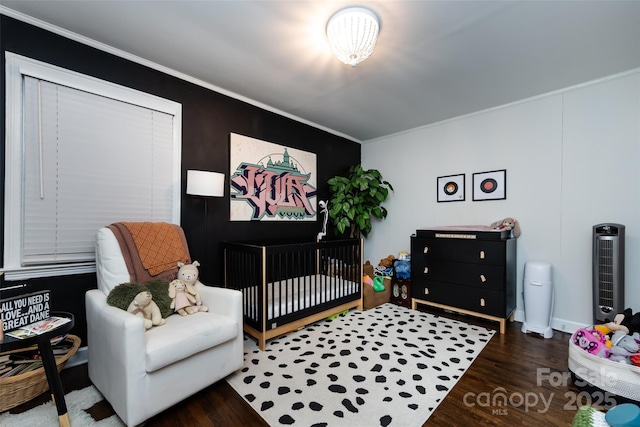 1816 Anderson St, Charlotte, NC 28205 - bedroom featuring crown molding, a crib, and wood finished floors