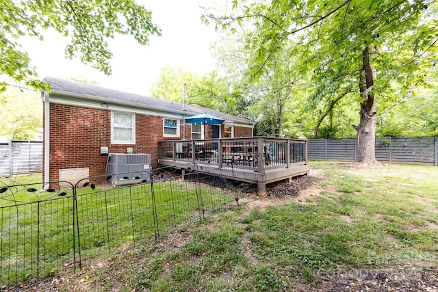 1816 Anderson St, Charlotte, NC 28205 - back of property featuring brick siding, a fenced backyard, a wooden deck, and cooling unit