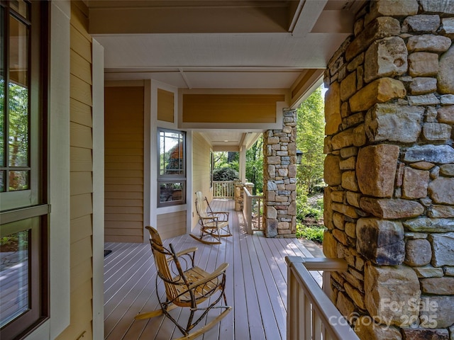 wooden terrace featuring covered porch